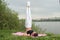 Fit woman making yoga in shoulderstand pose exercising in nature