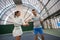 Fit woman with man coach training tennis concentrating on agility
