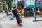 Fit woman performing weight lifting deadlift exercise with dumbbell at gym