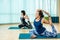 Fit woman practice yoga with friends, Young, woman in yoga class making beautiful asana exercises. Girl do mermaid pose,