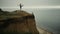 Fit woman practicing yoga asana on hilltop. Girl making gymnastic on beach.