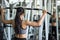 Fit woman pump back muscles exercise in gym