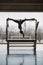 Fit woman turning upside and hanging up from trapeze table in pilates gym