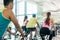 Fit women burning calories during indoor cycling class