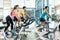 Fit women burning calories during indoor cycling class in the fitness club