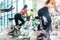 Fit women burning calories during indoor cycling class in a mode