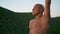 Fit yoga man concentrating at green landscape closeup. Focused bald athlete