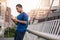 Fit young Asian man listening to music before a run