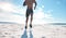 Fit young black man running and jogging at the beach in the morning while exercising. Closeup of one strong muscular