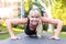 Fit young blond woman doing exercises in a park