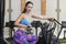 Fit young Caucasian woman using an air exercise bicycle at the gym or fitness studio