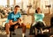 Fit young man and woman lifting dumbbells at the modern gym