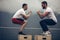 Fit young sportsmen doing box jumps as a group outdoor on top of the mountain