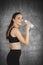 Fit young woman drinking milk from the bottle after exercise in gym. Beautiful woman at gym