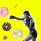 Fit young woman fighting off bad food, glaze cakes on color background. Female boxing with sweet donuts. Healthy eating