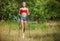 Fit young woman hiking with nordic walking poles