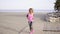 Fit young woman jogging on a beach