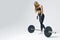 Fit young woman lifting barbell