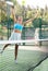 Fit young woman playing padel tennis on open court
