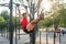 Fitnes man hanging on wall bars performing legs raises. Core cross training working out abs muscles