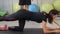 Fitnes woman lifting legs for biceps and buttocks with personal trainer in gym club. Sport woman training legs muscles