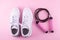 Fitness accessories concept. Top view photo of white sneakers and skipping, jump rope on isolated pink background. Flatlay