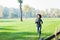 Fitness African Woman Jogging At Green Fields In Nature