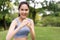 Fitness Asian Girl in tight sportswear doing exercises and punching boxing footwork cardio exercise in park. Female student boxer