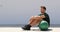 Fitness athlete man relaxing at fitness gym during medicine ball workout. Healthy and active lifestyle young adult