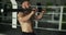 Fitness athlete uses barbell in training. Intense workout exercise. Slow motion