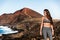 Fitness athlete woman sportswear model posing at mountain nature landscape background. Asian fit girl using smartwatch