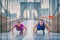 Fitness athletes training outdoors doing push-ups exercises workout on Brooklyn Bridge, New York city, Asian woman and