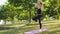 Fitness athletic Girl practicing yoga Outdoors standing on a one leg pose