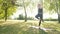 Fitness athletic Girl practicing yoga Outdoors standing on a one leg pose