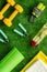 Fitness background - dumbbells, jump rope, sport carpet, water bottle - on green grass top-down pattern