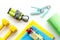 Fitness background - dumbbells, jump rope, sport carpet, water bottle - on white top-down