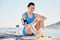 Fitness, beach and time with a sports woman on her watch during a workout by the ocean. Nature, water and clock with a