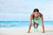 Fitness beach woman smiling planking doing yoga plank pose core exercises