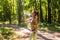 Fitness beautiful woman drinking water and sweating after exercising on summer hot day in park. Female athlete after