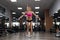 Fitness beautiful woman execute exercise with expander in gym