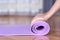 Fitness Begins at Home: Young Girl Preparing Yoga Mat on Parquet Floor