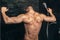 Fitness bodybuilder taking a shower after training. Close up details of back muscles in shower