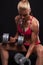 Fitness bodybuilder woman with dumbbells.beautiful blonde girl with muscles