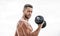 Fitness and bodybuilding sport. Gym workout concept. Dumbbell exercise gym. Muscular man exercising with dumbbell. Price