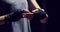 Fitness, boxing and training by athlete prepare for exercise, wrap hands against a black background. Boxer getting ready