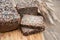 Fitness bread. A loaf of fresh rustic whole meal rye bread, sliced on a wooden board, rural food background. Close up.