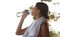 Fitness, break and woman with towel drinking water for break, hydration and commitment to yoga workout. Gym, bottle and
