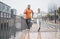Fitness, city and couple in the rain running for workout, marathon training and exercise in winter. Sports, wellness and