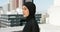 Fitness, city workout and muslim woman in hijab, head scarf and islamic fashion on building rooftop in urban Saudi
