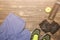 Fitness concept photo. Trainers, bottle of water, shorts and leather gloves. Fruit apple lying on wooden background. Healthy